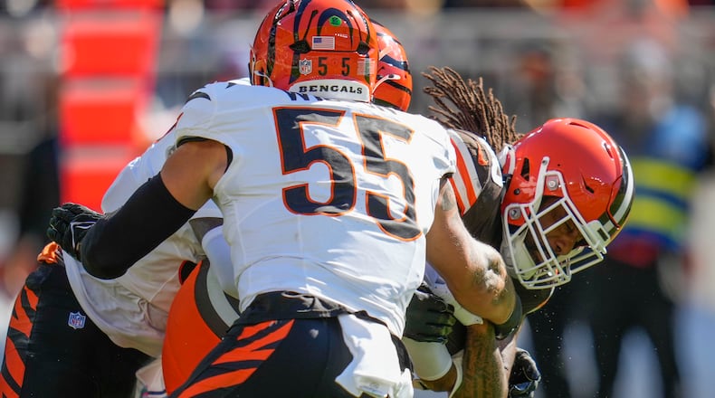 Cleveland Browns tight end Jordan Akins is tackled by Cincinnati Bengals linebacker Logan Wilson (55) in the first half of an NFL football game against the Cincinnati Bengals, Sunday, Oct. 20, 2024, in Cleveland. (AP Photo/Sue Ogrocki)