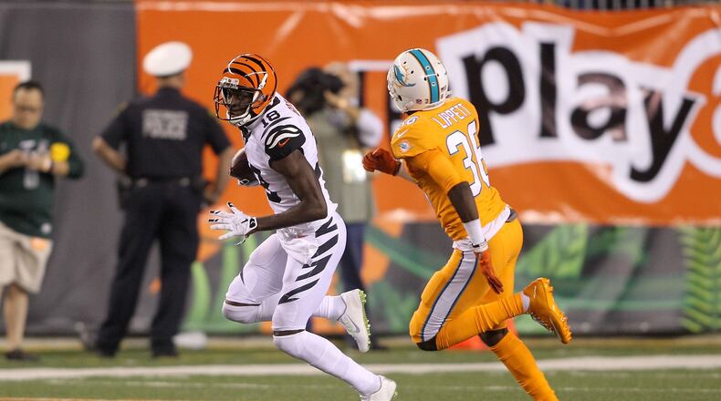 A.J. Green of the Cincinnati Bengals attempts to run the ball past Tony Lippett of the Miami Dolphins during the 2016 season at Cincinnati. (Photo by John Grieshop/Getty Images)