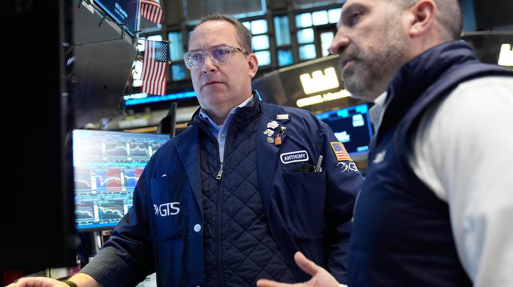 Anthony Matesic, left, and James Denaro work on the floor at the New York Stock Exchange in New York, Thursday, March 19, 2026. (AP Photo/Seth Wenig)