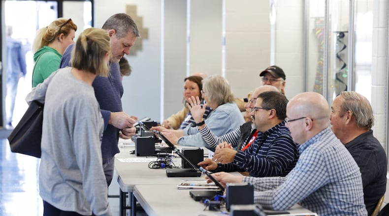 Poll workers help voters Tuesday, Nov. 8, 2022 at Edgewood Middle School. NICK GRAHAM/STAFF