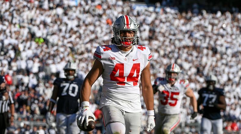Ohio State defensive end J.T. Tuimoloau (44) returns an interception for a touchdown during the fourth quarter of an NCAA college football game against Penn State, Saturday, Oct. 29, 2022, in State College, Pa. Ohio State won 44-31. (AP Photo/Barry Reeger)