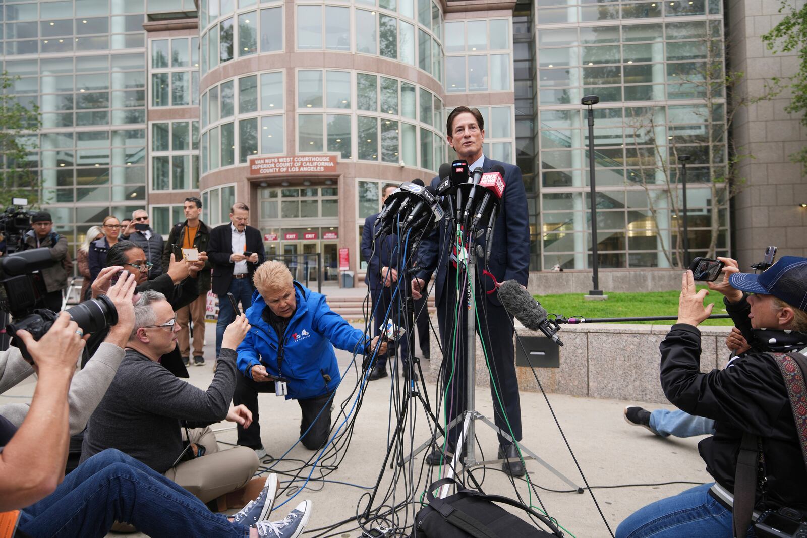 Los Angeles County District Attorney Nathan Hochman speaks outside of court before a hearing in the case of Erik and Lyle Menendez Thursday, April 17, 2025, in Los Angeles. (AP Photo/Damian Dovarganes)