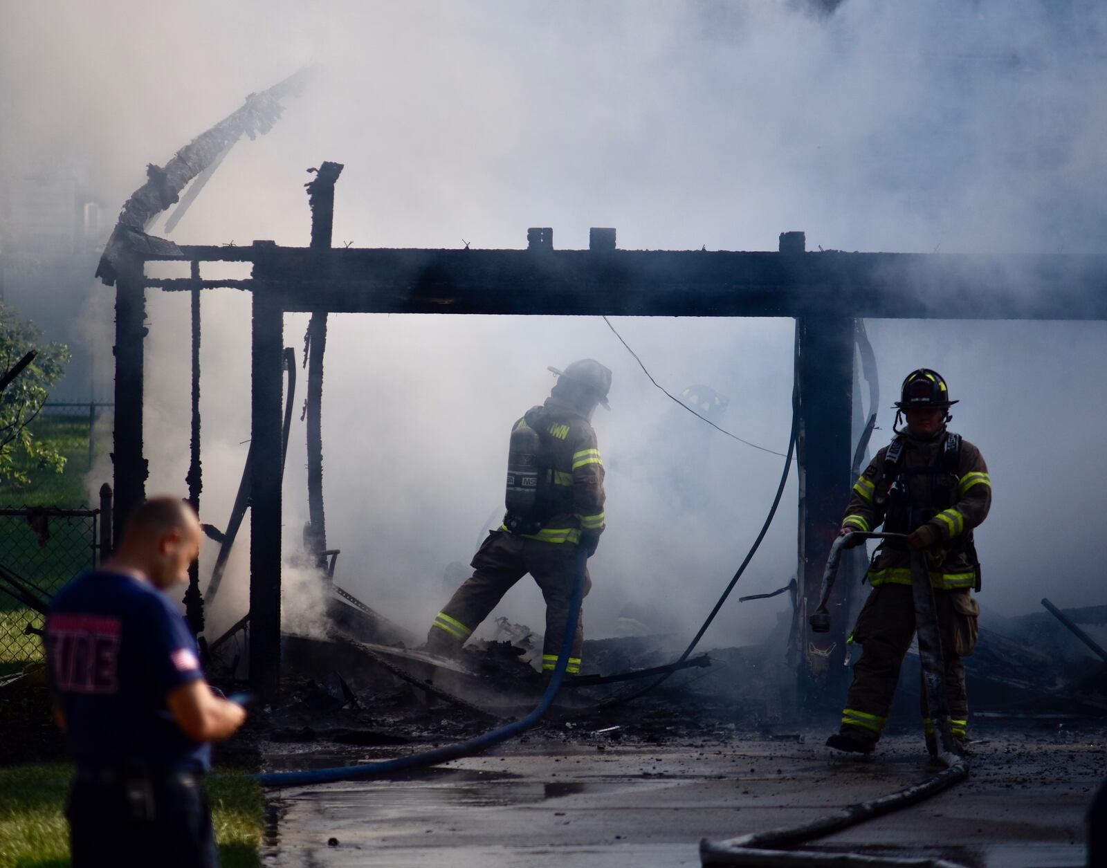 Firefighters work to extinguish a fire inside a detatched garage in Middletown Wednesday monring. Crews were dispatched at 8:40 a.m. to a garage engulfed in flames. NICK GRAHAM/STAFF
