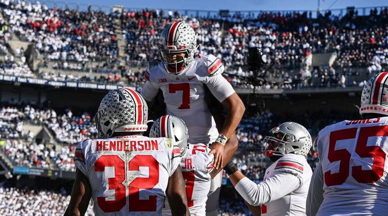 Ohio State quarterback C.J. Stroud (7) celebrates a touchdown with his teammates during the fourth quarter of an NCAA college football game against Penn State, Saturday, Oct. 29, 2022, in State College, Pa. Ohio State won 44-31. (AP Photo/Barry Reeger)