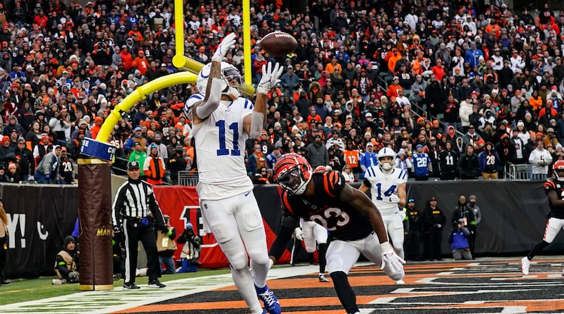 Indianapolis Colts wide receiver Michael Pittman Jr. (11) makes catch for a two-point conversion in front of Cincinnati Bengals safety Dax Hill (23) in the first half of an NFL football game in Cincinnati, Sunday, Dec. 10, 2023. (AP Photo/Carolyn Kaster)