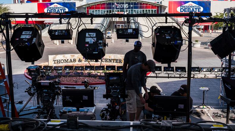 Television crews set up outside of the presidential debate site Monday Oct. 17, 2016 at the University of Nevada, Las Vegas in Las Vegas as preparation continue for the final debate between Democratic presidential nominee Hillary Clinton and Republican presidential nominee Donald Trump. (AP Photo/J. David Ake)