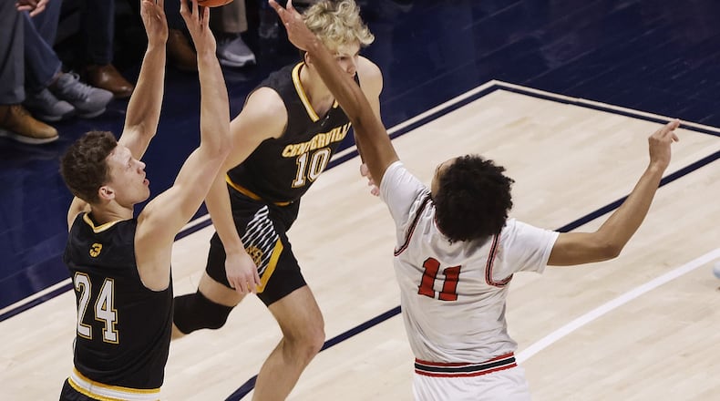 Centerville's Rich Rolf shoots over Fairfield's Logan Woods during Saturday night's Division I regional final at Xavier's Cintas Center. Nick Graham/STAFF