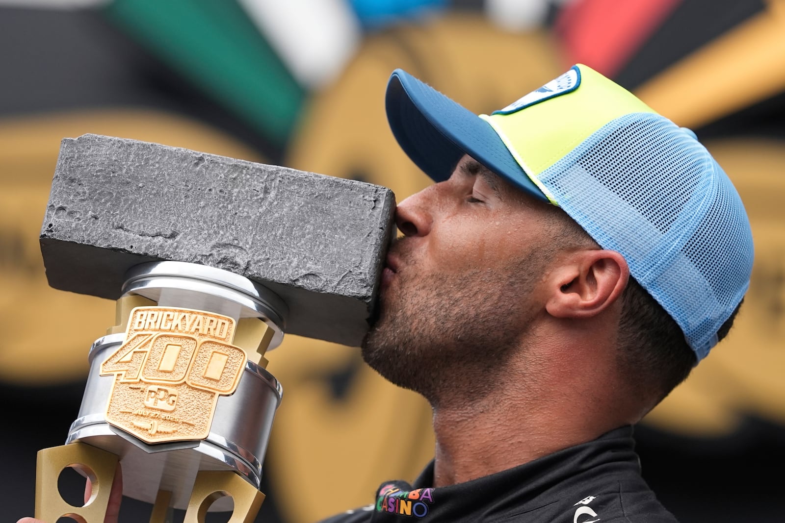 Bubba Wallace kisses the trophy after winning a NASCAR Cup Series auto race at Indianapolis Motor Speedway, Sunday, July 27, 2025, in Indianapolis. (AP Photo/Darron Cummings)