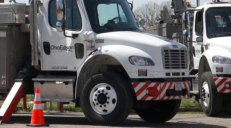 An Ohio Edison crew works on the power lines at the intersection of Urbana Road and Moorefield Road Wednesday, April 19, 2023. BILL LACKEY/STAFF