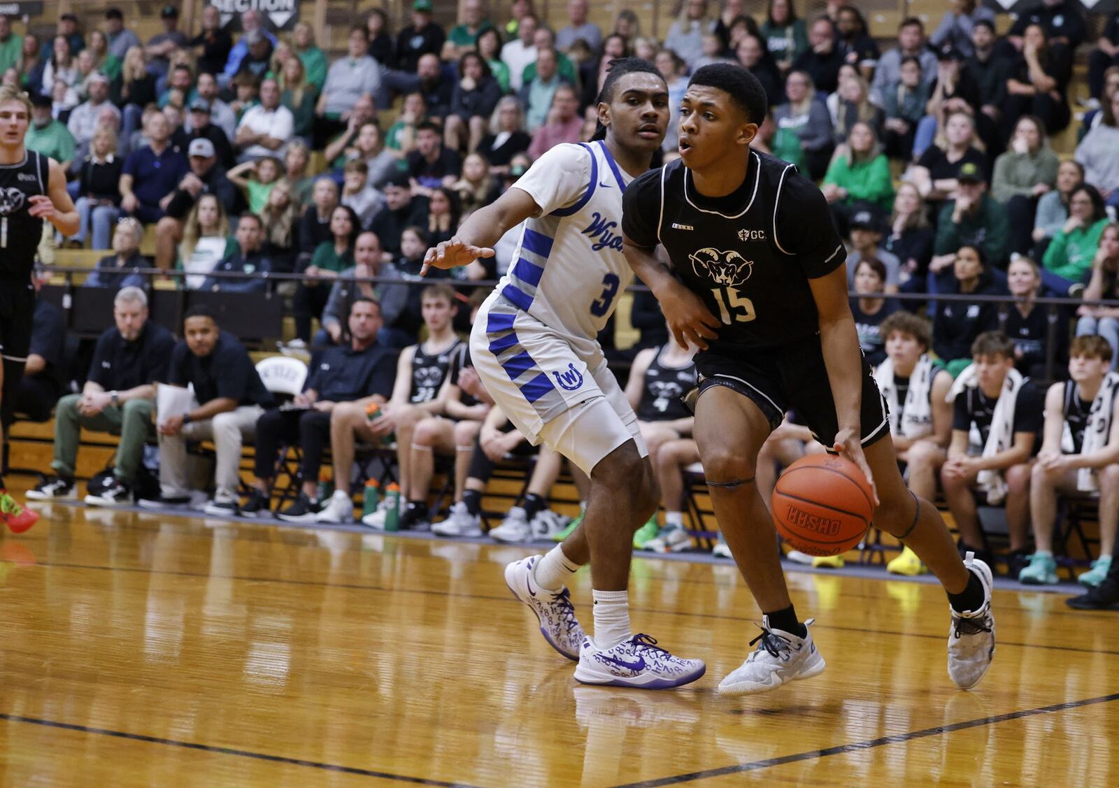 Badin's Chandler Taylor dribbles defended by Wyoming's  Darren Gray during their Division II Regional semifinal basketball game Thursday, March 14, 2024 at Vandalia Butler High School. Wyoming won 50-38. NICK GRAHAM/STAFF