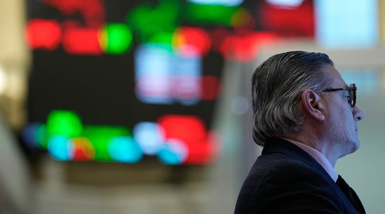 People work on the floor at the New York Stock Exchange in New York, Thursday, March 19, 2026. (AP Photo/Seth Wenig)