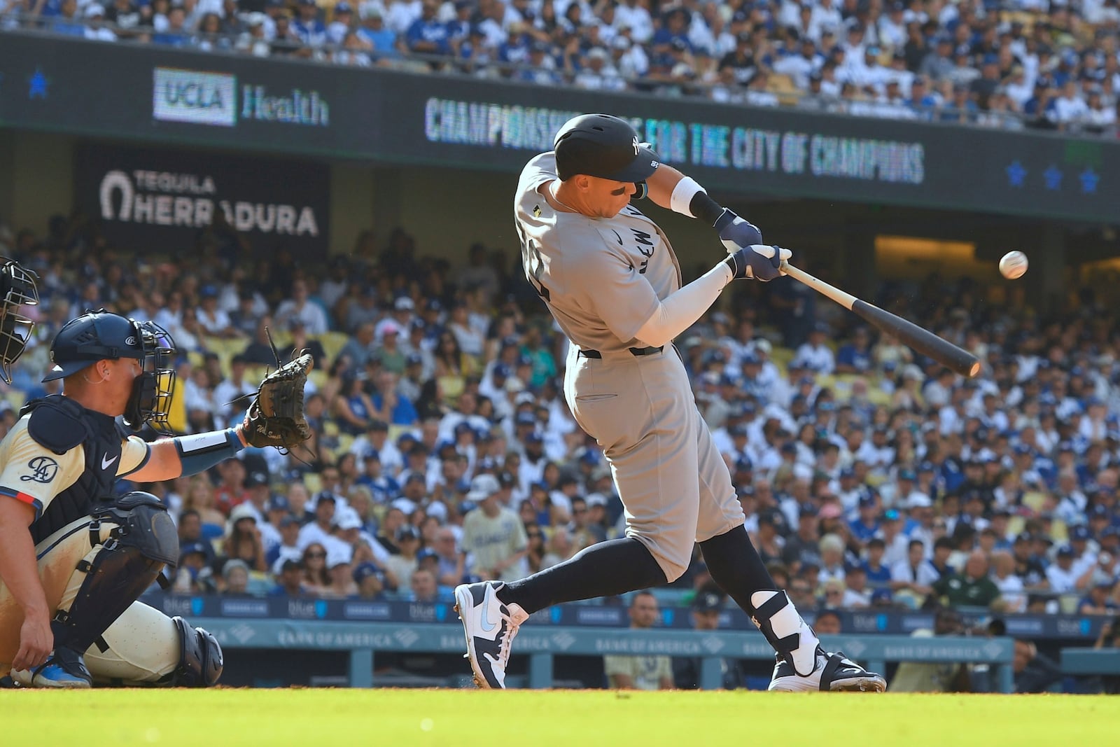 New York Yankees' Aaron Judge, right, hits a solo home run as Los Angeles Dodgers catcher Will Smith watches during the fourth inning of a baseball game Saturday, May 31, 2025, in Los Angeles. (AP Photo/Mark J. Terrill)