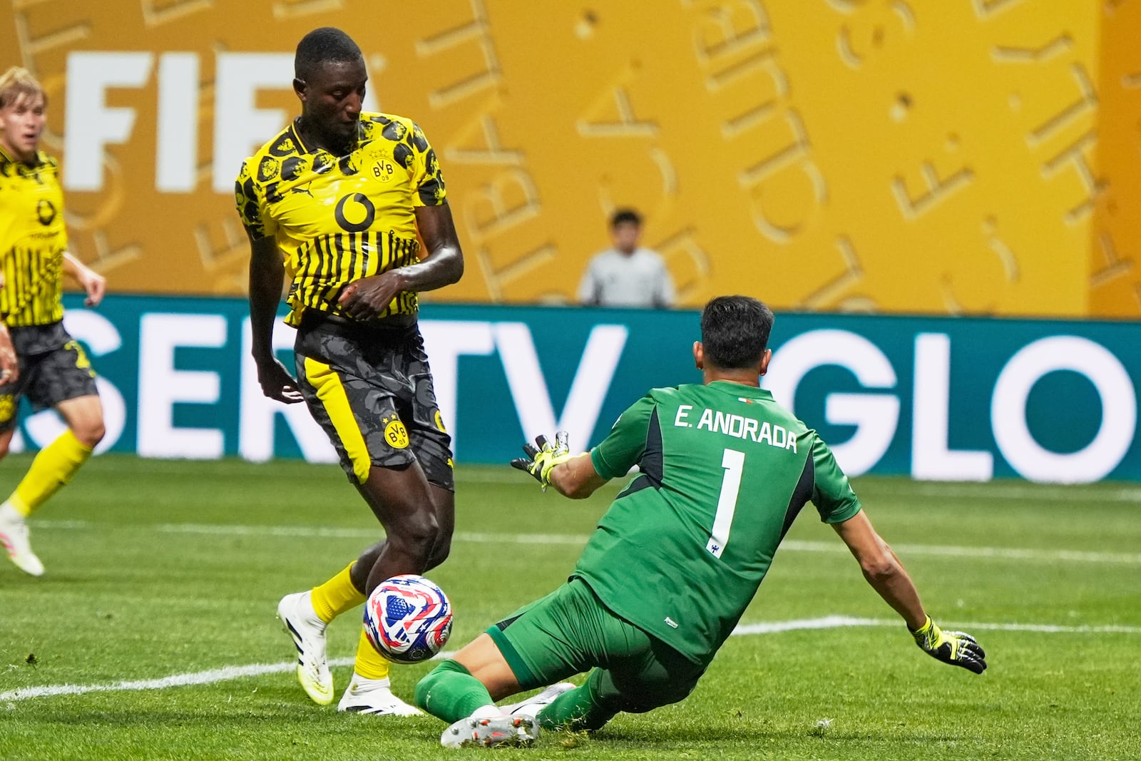 Borussia Dortmund's Serhou Guirassy, left, has his shot on goal blocked by Monterrey's goalkeeper Esteban Andrada during the Club World Cup round of 16 soccer match between Borussia Dortmund and CF Monterrey in Atlanta, Tuesday, July 1, 2025. (AP Photo/Mike Stewart)