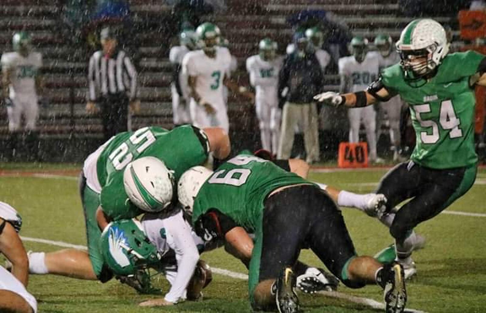Badin’s Dylan Schmitt (52) and Andrew Jones (64) bring down Chaminade Julienne quarterback Luke Chandler as Evan Schlensker (54) approaches the play Friday night at Fairfield Stadium in Fairfield. Badin won 38-21. CONTRIBUTED PHOTO BY TERRI ADAMS