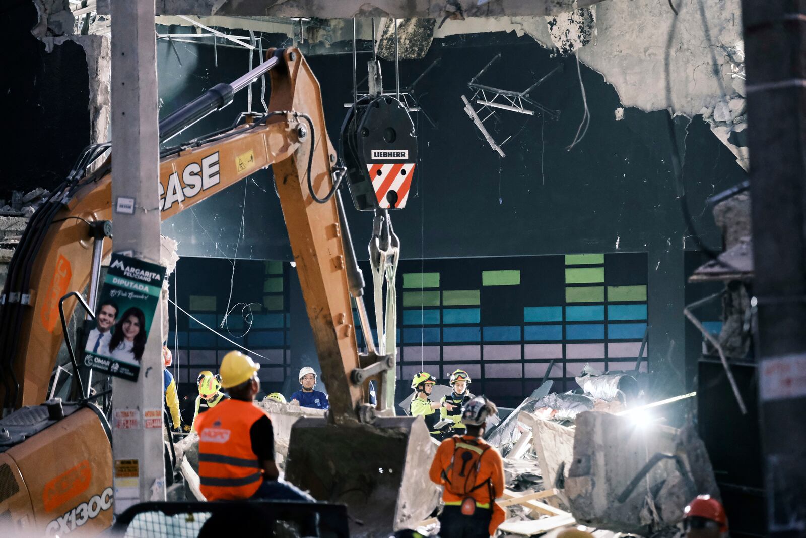 Rescue workers search for survivors at the Jet Set nightclub after its roof collapsed two nights before during a merengue concert in Santo Domingo, Dominican Republic, Wednesday, April 9, 2025. (AP Photo/Ricardo Hernandez)