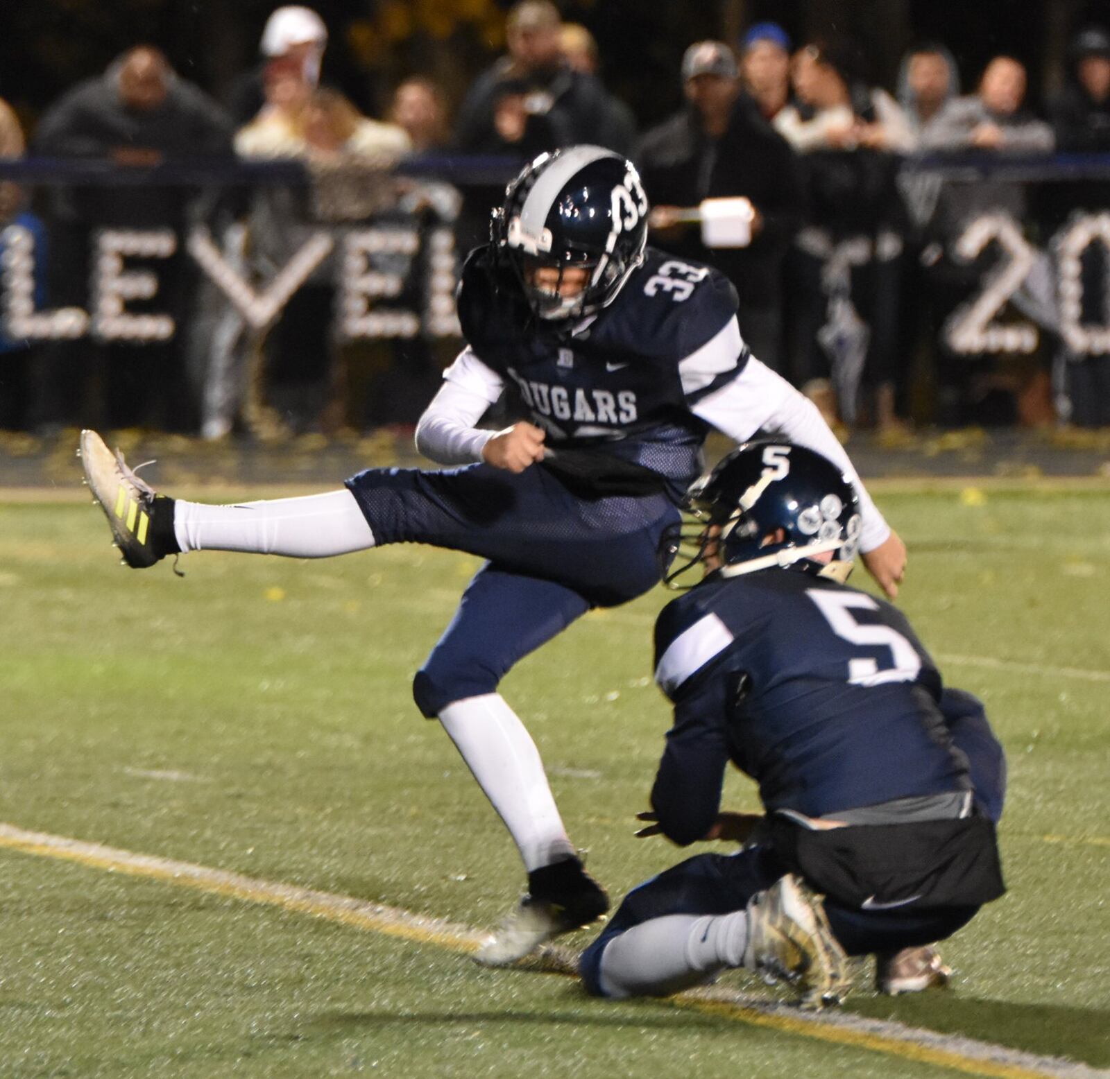Edgewood’s Dustin Turner follows through on a kick as holder Corbin Craft watches Friday night during a Division II, Region 8 playoff game against Little Miami at Kumler Field in St. Clair Township. Edgewood dropped a 10-7 decision. CONTRIBUTED PHOTO BY DAWN JOSEPH