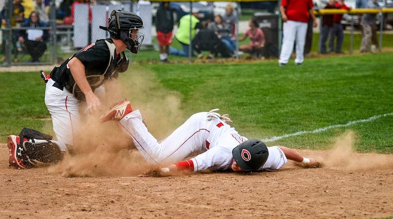 Madison’s Cameron Svarda tags out Carlisle’s Adam Goodpaster at home during a game April 5, 2017, at Carlisle. NICK GRAHAM/STAFF