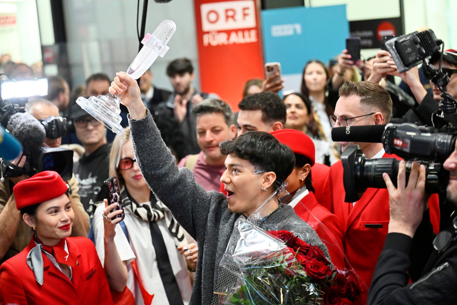 JJ, center, from Austria arrives at the airport in Vienna, Austria, Sunday, May 18, 2025, after winning the Grand Final of the 69th Eurovision Song Contest, in Basel yesterday. (AP Photo/Denes Erdos)
