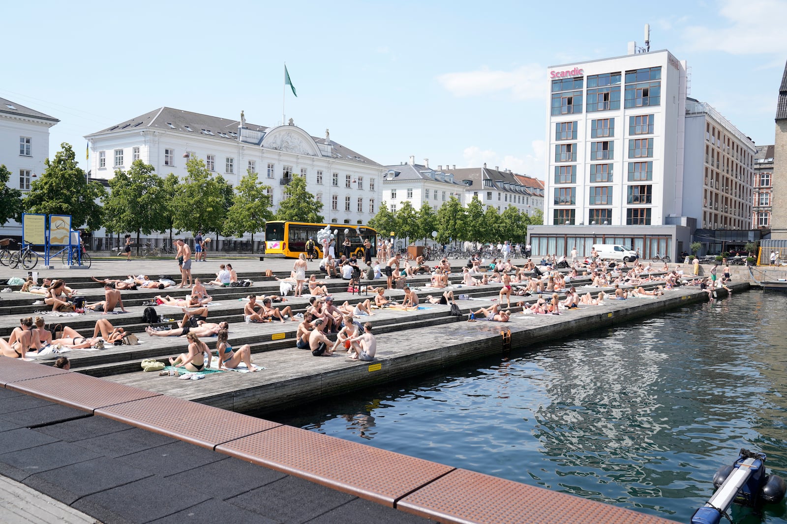 People relax at the the harbour bath at Ofelia Square in Copenhagen, Denmark, Wednesday July 2, 2025. (Thomas Traasdahl/Ritzau Scanpix via AP)
