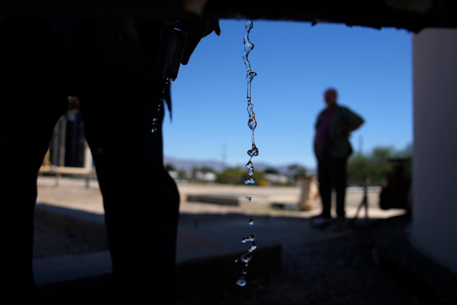 FILE - Water drips from a faucet as water operator Robert Tipton checks equipment for a well at the Wenden Domestic Water Improvement District's offices, Oct. 17, 2023, in Wenden, Ariz. (AP Photo/John Locher, File)