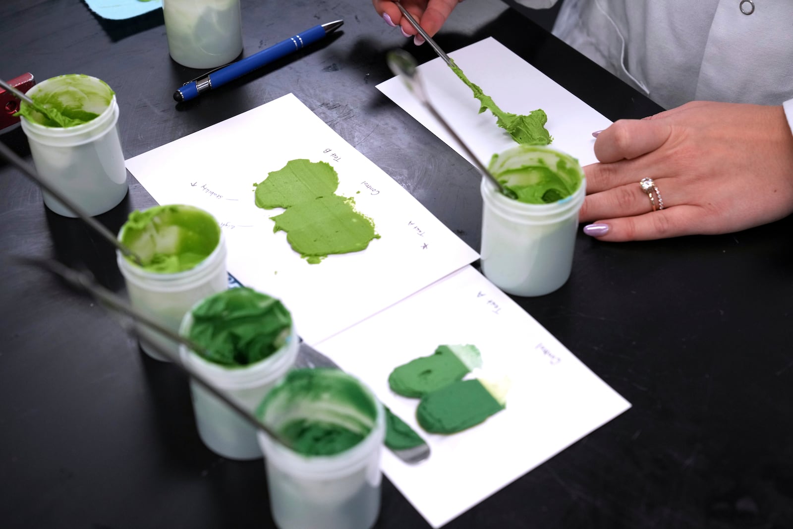 Senior Application Scientist Nicole Carey works in a lab to match food coloring at Sensient Technologies Corp., a color additive manufacturing company, in St. Louis, on Wednesday, April 2, 2025. (AP Photo/Jeff Roberson)