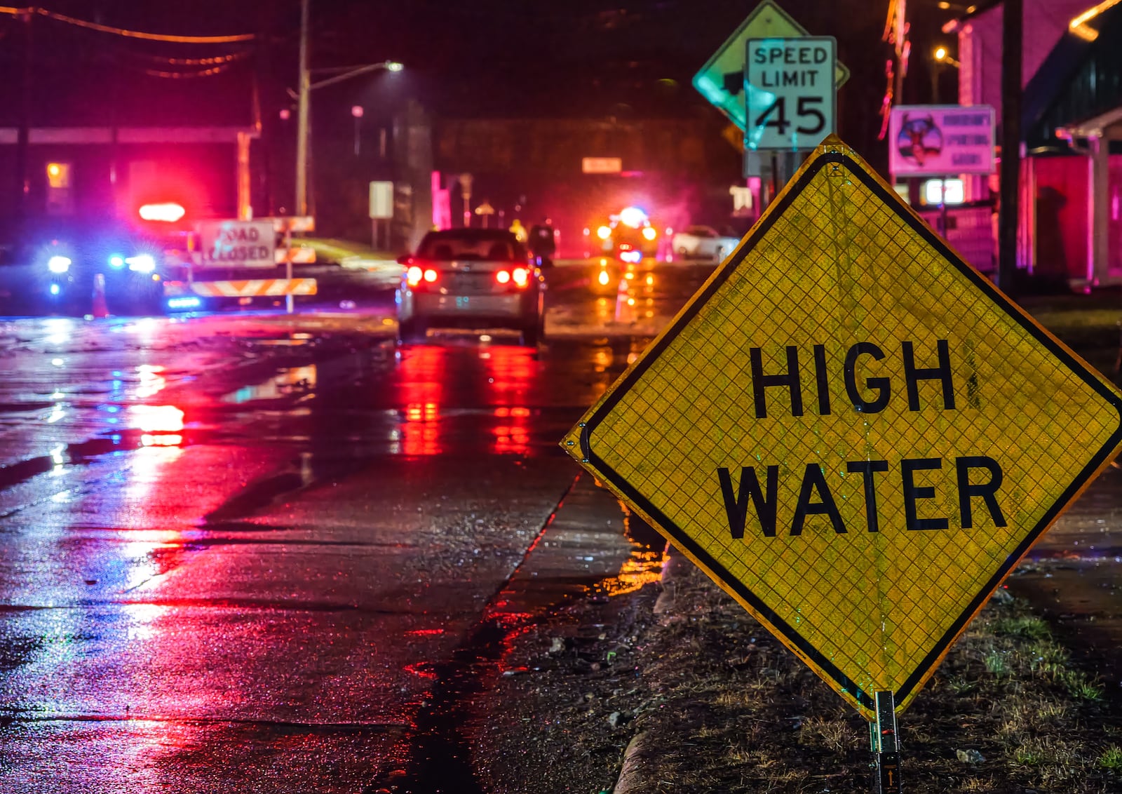 A crew from Ohio Department of Transportation works to clear drains on a flooded Germantown Road early Thursday morning, March 5, 2026 in Madison Township in Butler County. Heavy rain caused flooding in many areas. NICK GRAHAM/STAFF