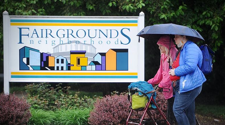A look at walkers trying to stay dry while on Brown Street Thursday, April 29, 2021. There will be showers and storms most of the day.