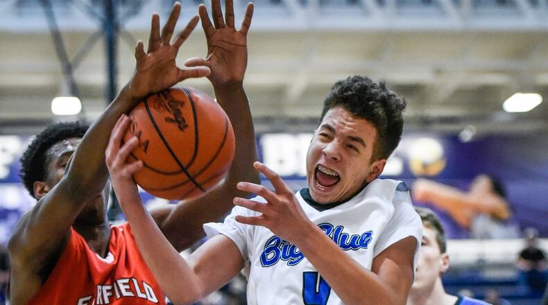 Fairfield’s Devonte Ross defends a shot by Hamilton’s Jaylen Robinson during Tuesday night’s game at the Hamilton Athletic Center. NICK GRAHAM/STAFF