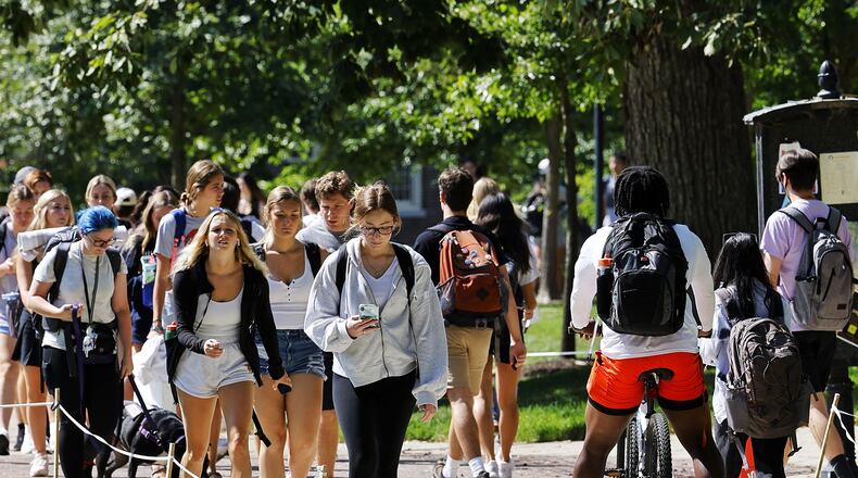 Students walk on campus between classes at Miami University Aug. 24, 2022 in Oxford. NICK GRAHAM/STAFF