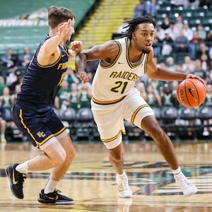 Wright State junior guard Logan Woods dribbles with pressure from Franklin College's David Streitmatter during a season opener on Monday, Nov. 3 at Ervin J. Nutter Center in Fairborn. BRYANT BILLING/STAFF