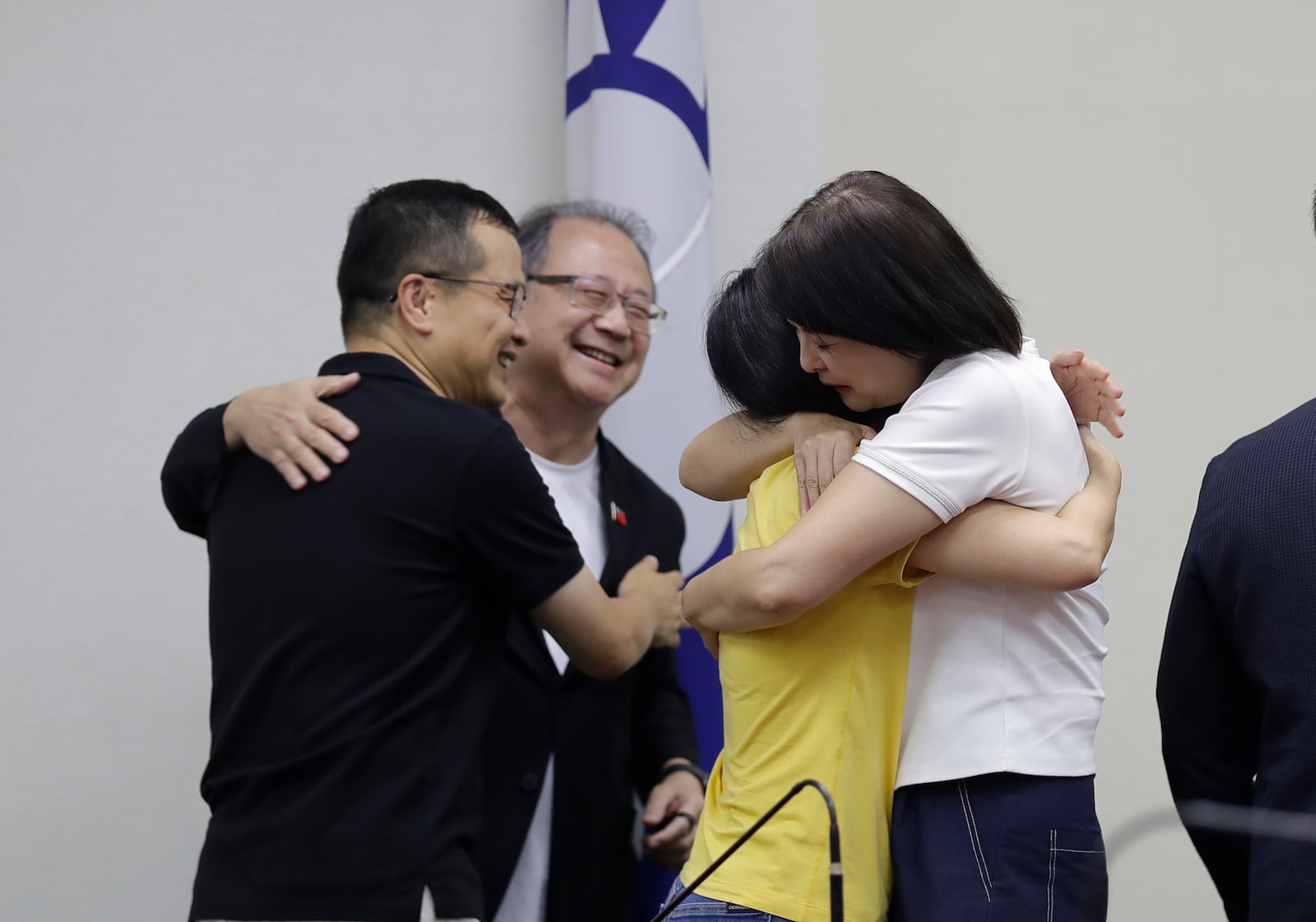 Lawmakers of Taiwan Opposition Nationalist Party and party staff cheer after a press conference in Taipei, Taiwan, Saturday, July 26, 2025. (AP Photo/Chiang Ying-ying)