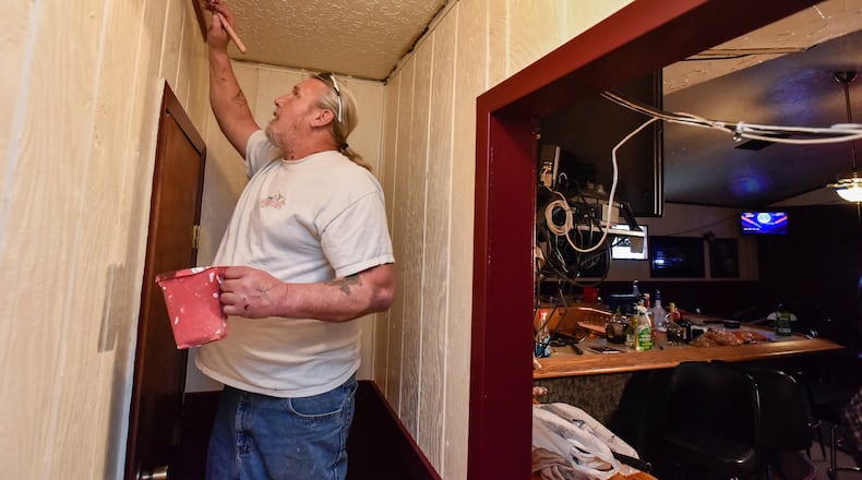 Raymond Ray paints trim inside the C & C Lounge Tuesday, March 31 in Ross Township. The C & C Lounge was one of several places given letters to stop business temporarily by the Butler County Board of Health during the coronavirus pandemic. The lounge also serves as office space for the Ross Motel situated behind it. NICK GRAHAM / STAFF