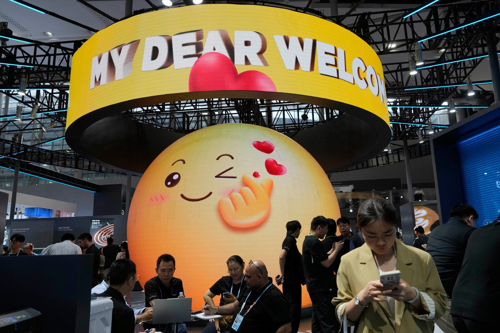 A smiley face greets visitors at the booth for Midea, a Chinese home appliances company, during the 137th Canton Fair in Guangzhou in southern China's Guangdong province, Tuesday, April 15, 2025. (AP Photo/Ng Han Guan)