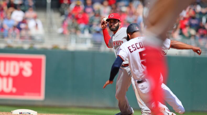 MINNEAPOLIS, MN - APRIL 29: Jose Peraza #9 of the Cincinnati Reds turns the double play on Eduardo Escobar #5 of the Minnesota Twins in the seventh inning at Target Field on April 29, 2018 in Minneapolis, Minnesota. (Photo by Adam Bettcher/Getty Images)
