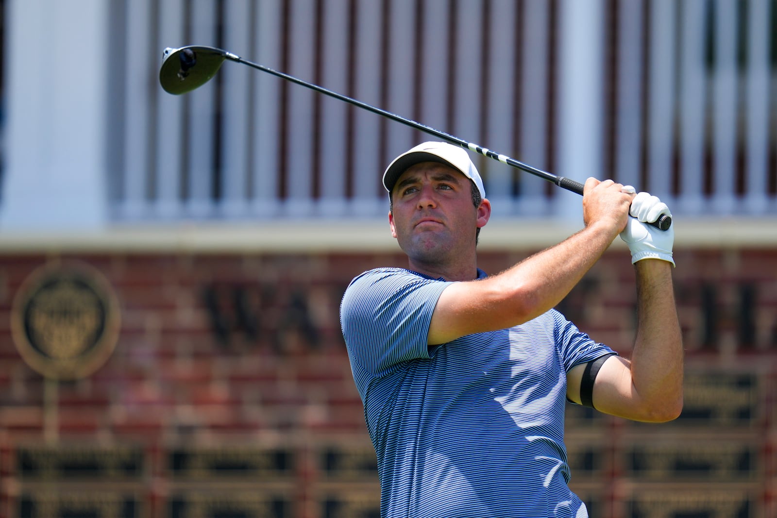 Scottie Scheffler watches his tee shot on the first hole during the first round of the Charles Schwab Challenge golf tournament at Colonial Country Club in Fort Worth, Texas, Thursday, May 22, 2025. (AP Photo/Julio Cortez)