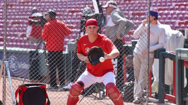 Reds catcher Tyler Stephenson warms up on Opening Day on Thursday, March 30, 2023, at Great American Ball Park in Cincinnati. David Jablonski/Staff