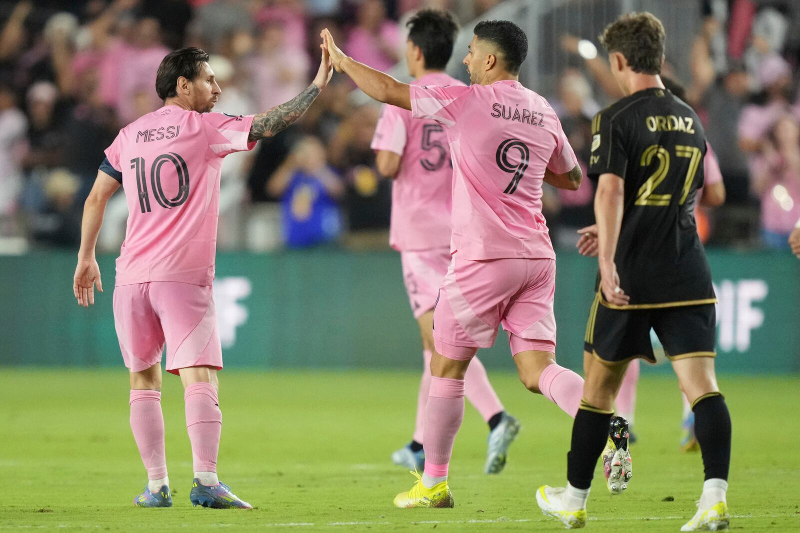 Inter Miami forward Lionel Messi (10) celebrates a goal with forward Luis Suárez (9) against the Los Angeles FC during the first half of a CONCACAF Nations League Quarterfinal Match at Chase Stadium, Wednesday, April 9, 2025 in Fort Lauderdale, Fla. (AP Photo/Jim Rassol)