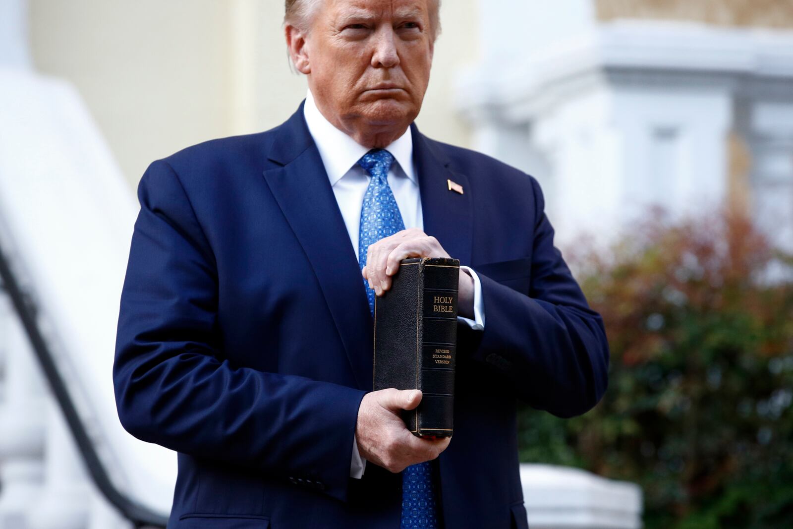 FILE - President Donald Trump holds a Bible as he visits outside St. John's Church across Lafayette Park from the White House in Washington, June 1, 2020. (AP Photo/Patrick Semansky, File)