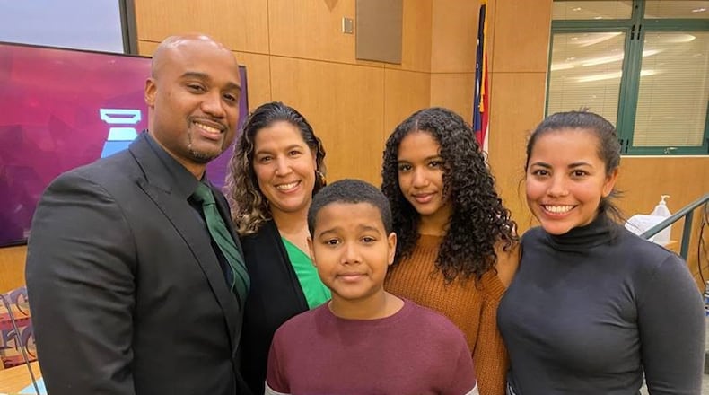 Newly sworn-in Mason Board of Education member Ian Orr, left, posed with members of his family after taking his seat on the board of Warren County's largest school system. Orr is the first African American to hold a seat on Mason's governing board in the district's history, which stretches back to the first half of the last century. (Provided Photo\Journal-News)