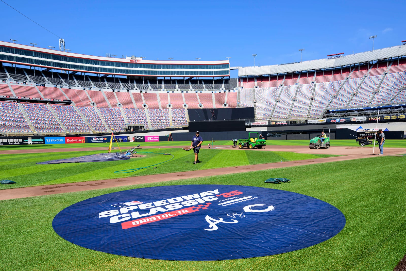 Work continues on the baseball field inside the racetrack at Bristol Motor Speedway, Friday, July 25, 2025, in Bristol, Tenn., for MLB Speedway Classic baseball game between the Cincinnati Reds and Atlanta Braves on Aug. 2. (Earl Neikirk/Bristol Motor Speedway via AP