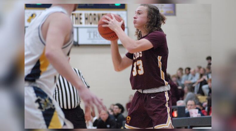 Ross sophomore Ben Voegele looks to make a pass during Tuesday night's game at Monroe. Chris Vogt/CONTRIBUTED