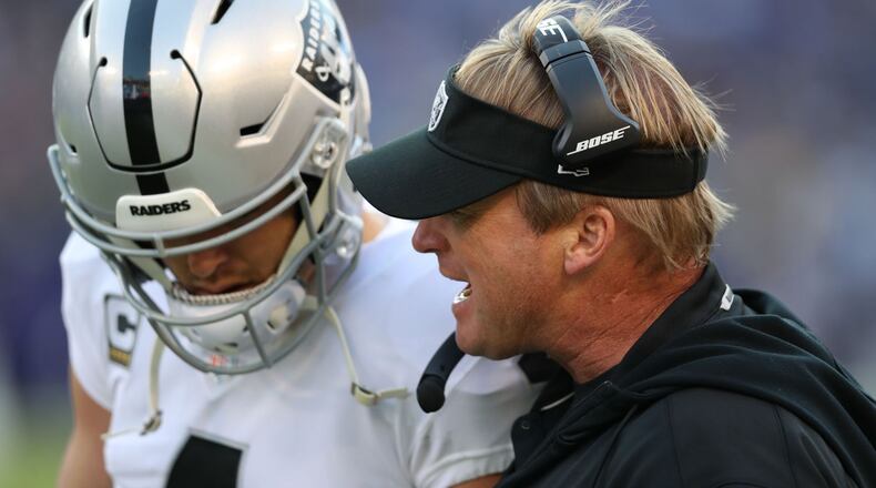 BALTIMORE, MARYLAND - NOVEMBER 25: Head Coach Jon Gruden of the Oakland Raiders talks with quarterback Derek Carr #4 during the fourth quarter against the Baltimore Ravens at M&T Bank Stadium on November 25, 2018 in Baltimore, Maryland. (Photo by Rob Carr/Getty Images)