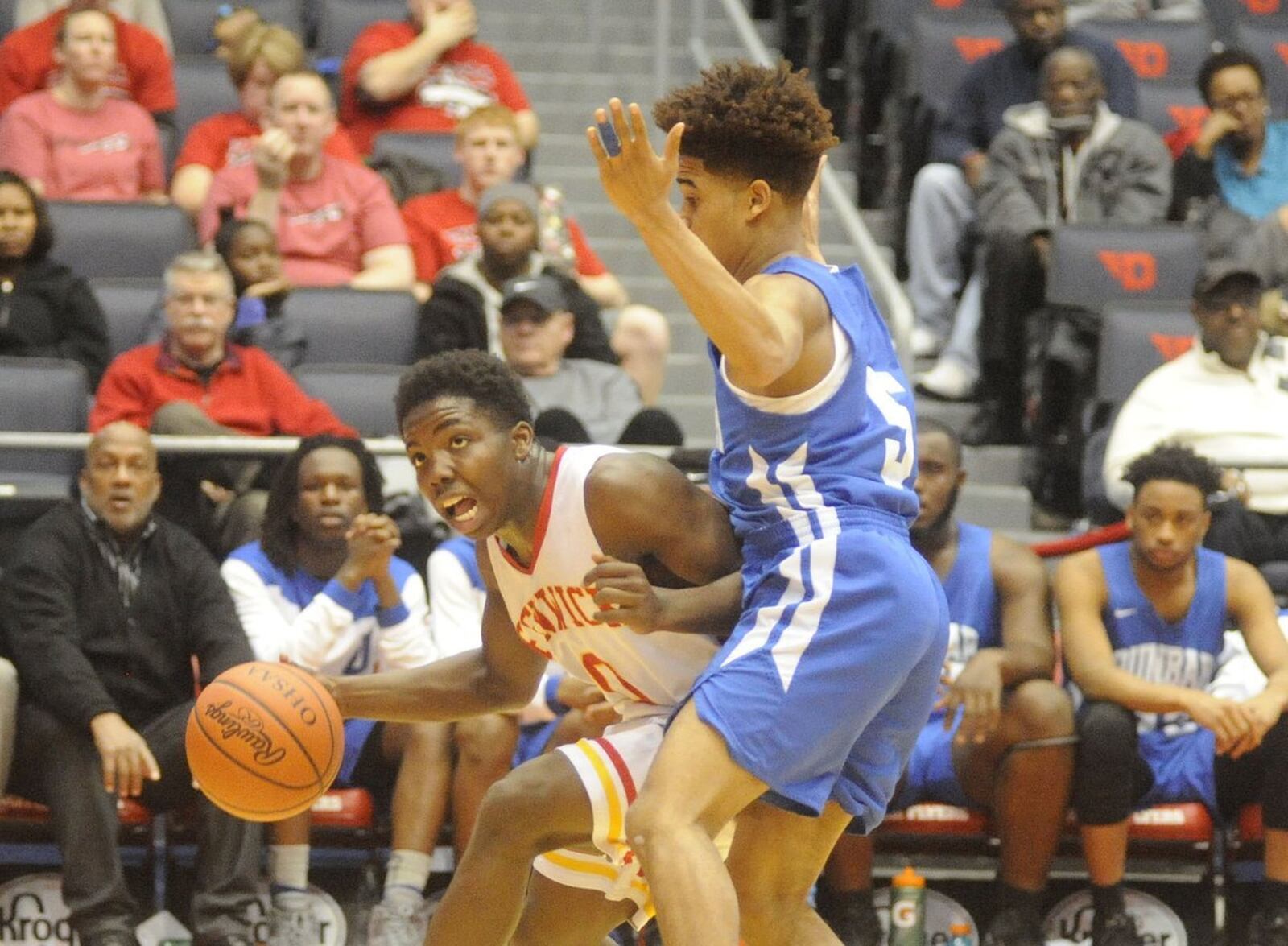 Fenwick’s Caleb Davis (0) tries to drive past Kadar Gardner (5) of Dunbar during Wednesday night’s Division II sectional final at the University of Dayton Arena. MARC PENDLETON/STAFF