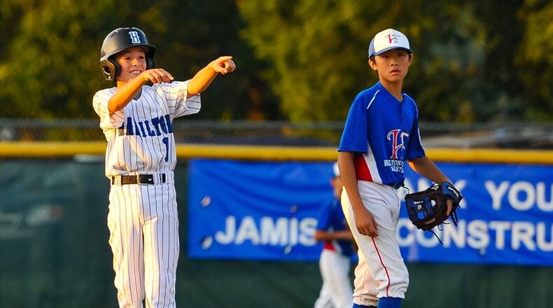 Hamilton West Side’s Clint Moak celebrates a hit during last week’s District 9 championship victory over Hamilton-Fairfield at West Side. NICK GRAHAM/STAFF