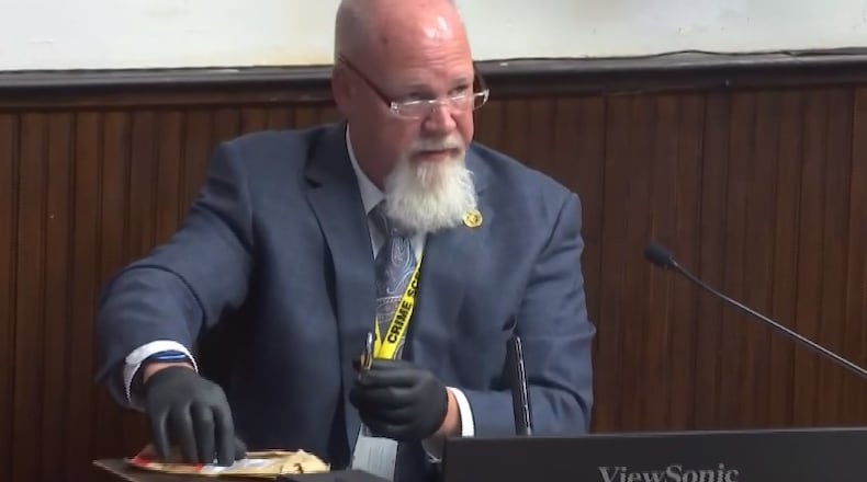 BCI investigator George Edward Staley is seen on the stand in the trial of George Wagner IV, who is accused of killing eight members of the Rhoden family in Pike County, Ohio in 2016. In this photo he is identifying a lock on a door at the crime scene. CONTRIBUTED