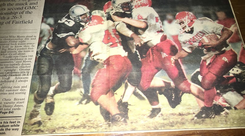 Fairfield’s Gerome Jones chops his feet in the muck of Virgil Schwarm Stadium while teammate Matt Traxler (46) leads the way against Hamilton’s Gary Richardson during a Week 9 game in 1997. GREG LYNCH/STAFF