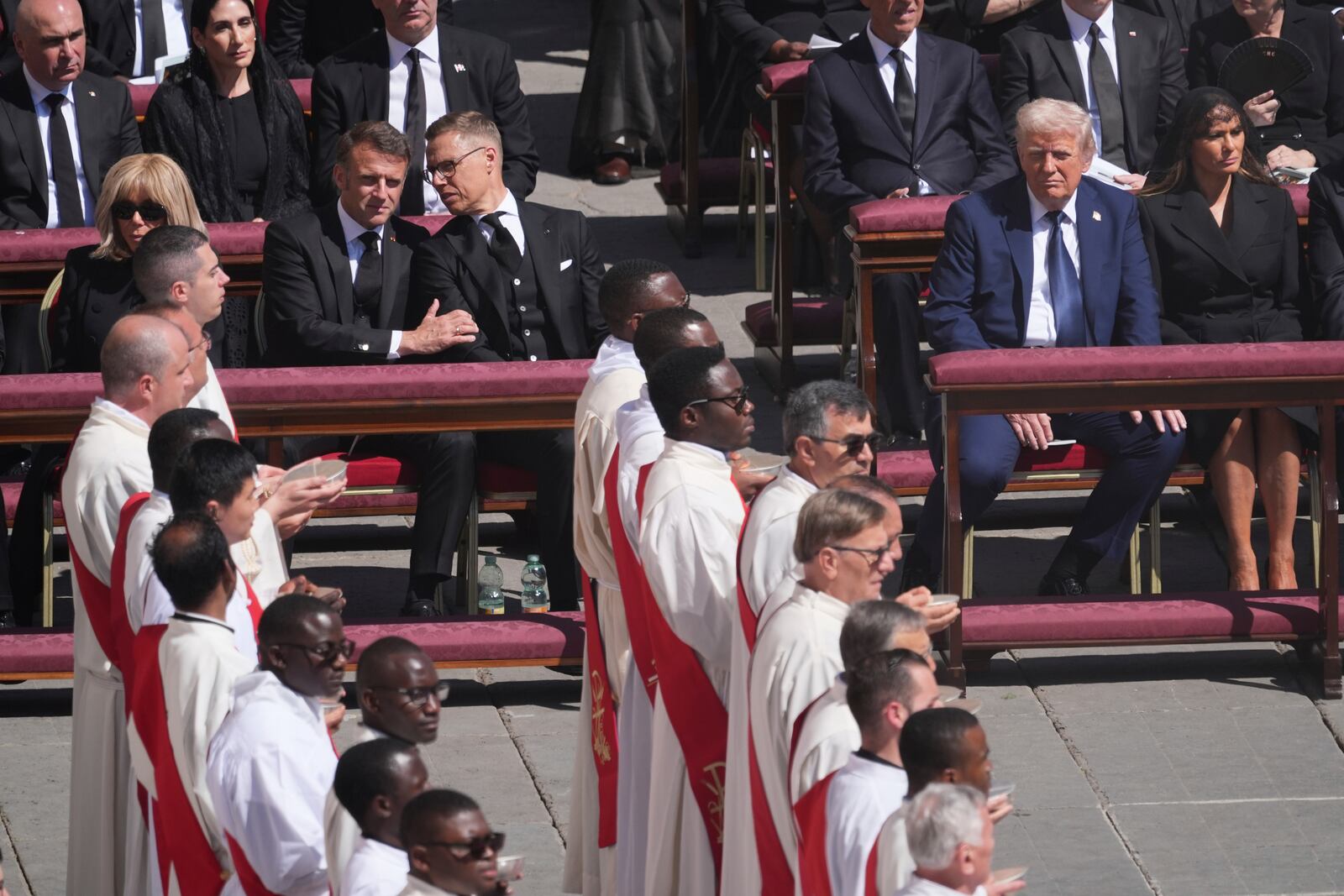 President Donald Trump, second right, with first lady Melania Trump, right, French President Emmanuel Macron, front row left, with Brigitte Macron, left, and Finland's President Alexander Stubb, third left, attend the funeral of Pope Francis in St. Peter's Square at the Vatican, Saturday, April 26, 2025. (AP Photo/Evan Vucci)