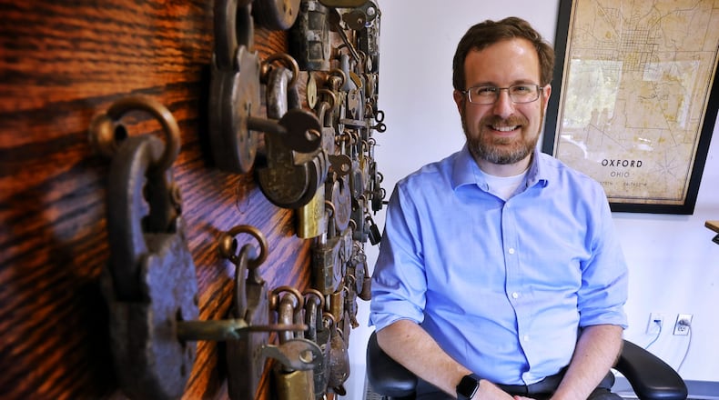 David Seidl, Miami University's vice president for information technology and chief information officer, has a unique hobby of picking locks and has a display board of  vintage locks behind his desk that his grandfather collected as a locksmith. NICK GRAHAM/STAFF