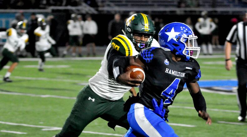 Hamilton's Jaylan Garrett, 4, attempts to get around a Sycamore defender during the first quarter of a Greater Miami Conference game on Friday, Oct. 21. DAVID A. MOODIE/CONTRIBUTING PHOTOGRAPHER