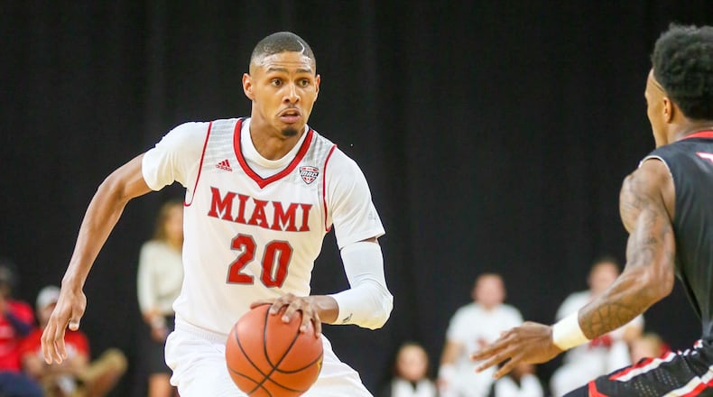 Miami guard Dion Wade (20), avoids a defender during their season opener against Muskingum, at Millett Hall in Oxford, Friday, Nov. 11, 2016. GREG LYNCH / STAFF